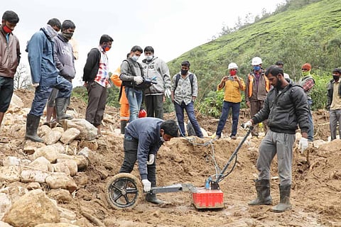 Rescue workers in Pettimudi using special radar to detect bodies