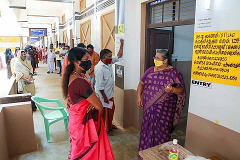 Voters waiting in front of a polling booth in Kerala