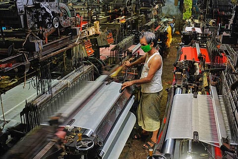  An employee works at a powerloom