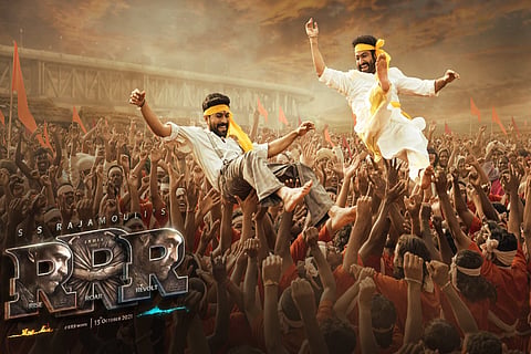 Jr NTR and Ram Charan are lifted up by the men around them and are seen celebrating. 