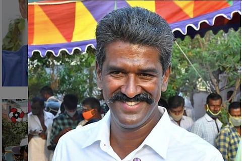Close up of R Mahendran in a white T shirt 