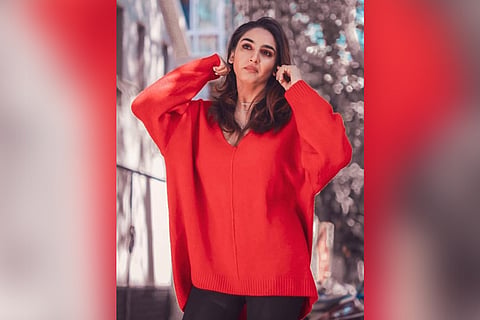 Ragini Dwivedi wearing a red pullover