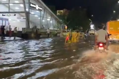 Vehicles driving through an inundated road in Chennai