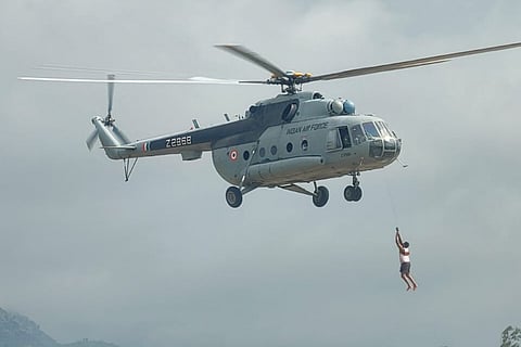 A man stranded in a river being rescued by the Indian Air Force helicopter