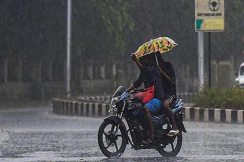 Man riding bike in the rains