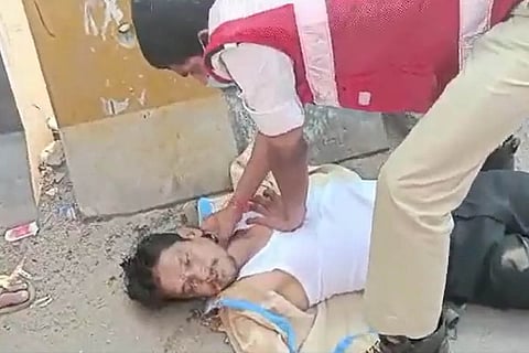 A traffic cop performing CPR on a person, Balaji
