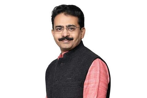 Congress leader Rajeev Satav wearing a pink kurta and a grey Nehru jacket and looking into camera