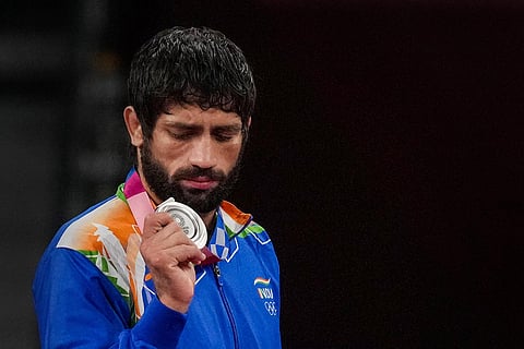 Ravi Kumar Dahiya holding his silver medal