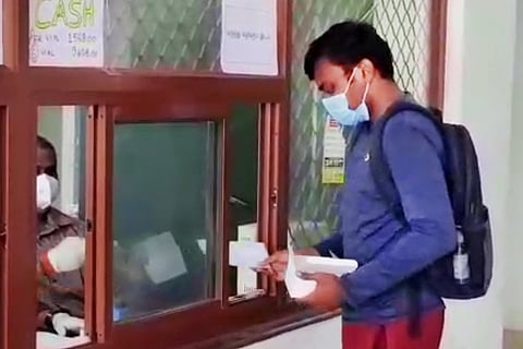 A person purchasing remdesivir vials at a counter. 