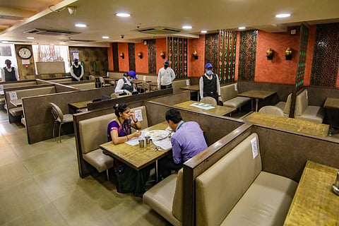 A restaurant with two people sitting at a table