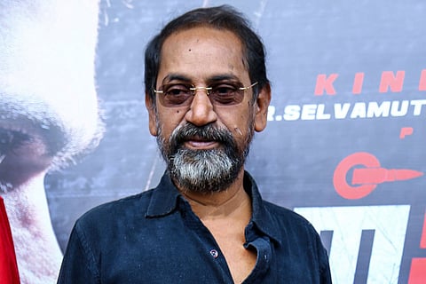 Director SP Jananathan is seen in a blue shirt in an event. 