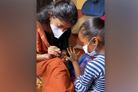 Sai Pallavi putting mehendi for a child 