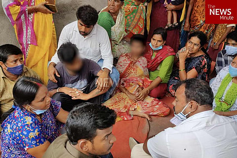 The family of the victim gathered together outside their house