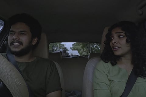 Jithin and Rima Kallingal sitting in a car in Santhoshathinte Onnam Rahasyam
