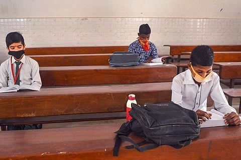 Masked students in a classroom 