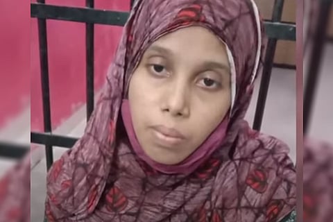 Accused Shahida looks forward with a grim face