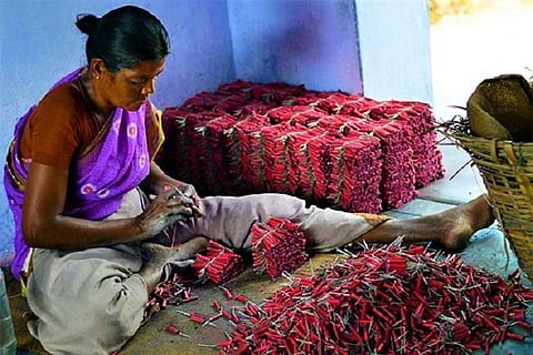 A cracker maker rolling the crackers