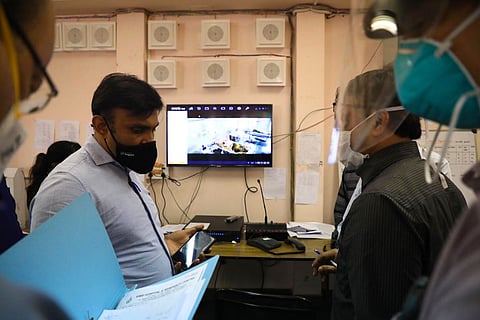 Medical Education Minister Sudhakar K at KIMS Bengaluru wearing a mask and addressing officials