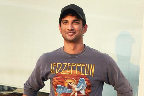 late actor Sushant Singh is seen in a full sleeved grey T shirt and cap, sporting a casual look. 
