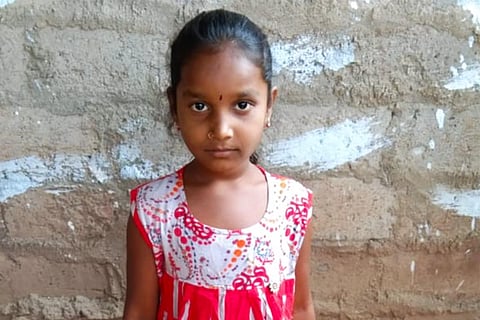 An image of Tulasi looking into the camera