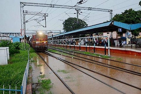 A train approaching a station on a misty day