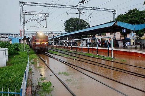 Train passing through flooded railway tracks