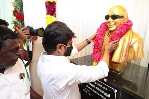 Udhayanidhi Stalin at Tirukkuvalai garlanding a statue of his late grandfather and former CM Karunanidhi