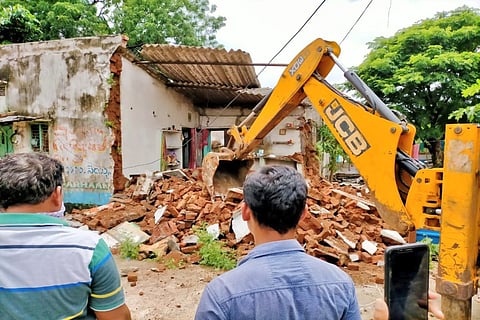 Authorities demolishing a dilapidated house in Warangal 
