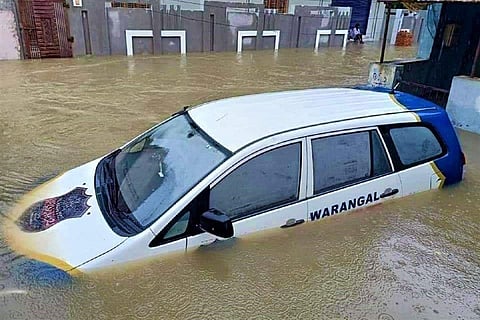 A car of the Warangal police drowns as water flooded parts of the city 