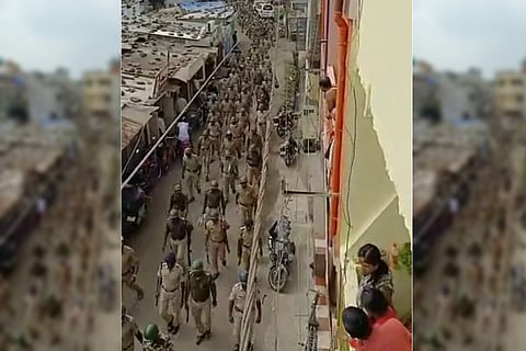 Washim police carrying out a route march to maintain law and order 