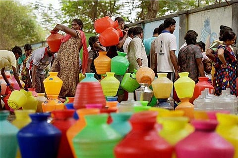 Representative image of people collecting water from a tap