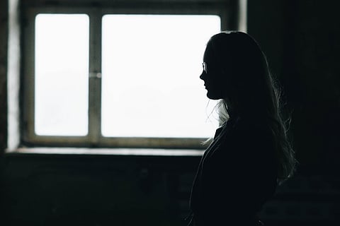 Representative image of a silhouette of a woman against a window
