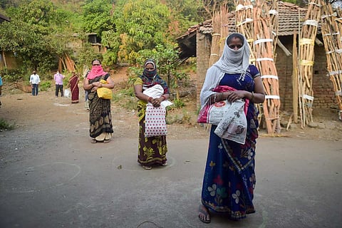 Row of woman standing, faces covered following social distancing