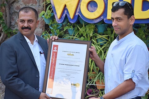 Arun K Chittilappilly, MD of Wonderla holidays receiving the COV-safe certificate