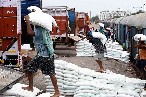 Labourers at a railway station.