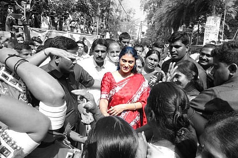 YS Sharmila, dressed in a red sari, amidst a crowd 