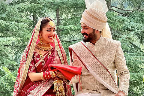 Yami Gautam is in red bridal saree, while Aditya is seen in a festive sherwani and turban in an image from the couple's wedding.