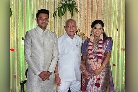 Yediyurappa posing with his granddaughter Soundarya and her husband Neeraj at their wedding
