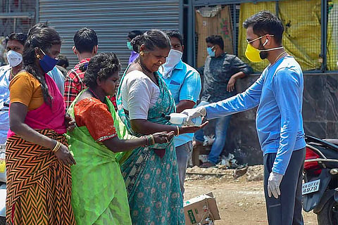 A youth distributing COVID-19 relief materials