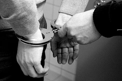 Representative image of a man being handcuffed