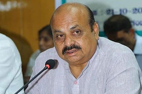 Karnataka CM Basavaraj Bommai speaking in front of a microphone