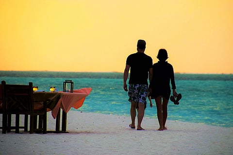 A couple walking on a beach 