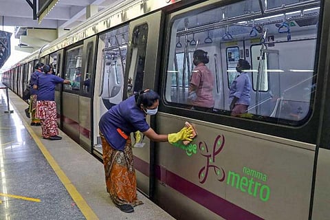 Metro workers cleaning train