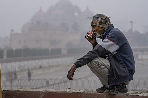 Man sitting in the cold drinking a beverage