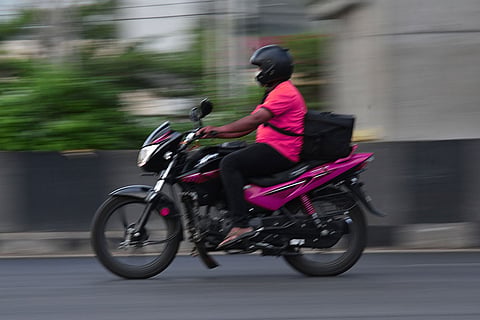 A delivery person riding a bike