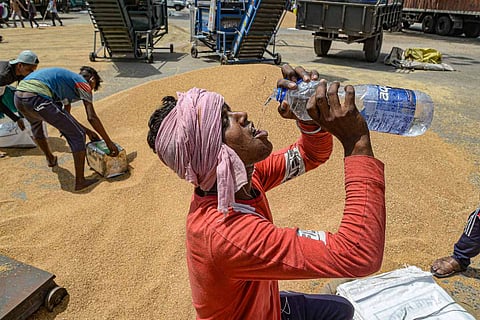 Representative image of a man drinking water on a hot day 