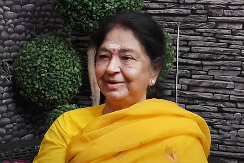 Indira Kumari wears a yellow saree at an interview 