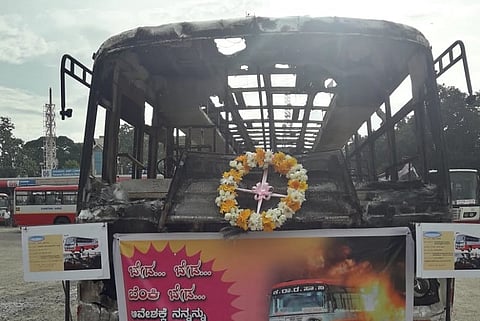 At Bengaluru bus stand, a burnt bus asks commuters to refrain from vandalism
