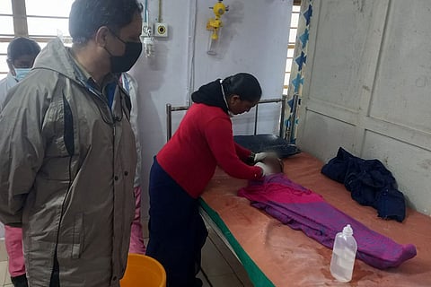 Doctors attend to four-year-old Saridha who was attacked by a leopard