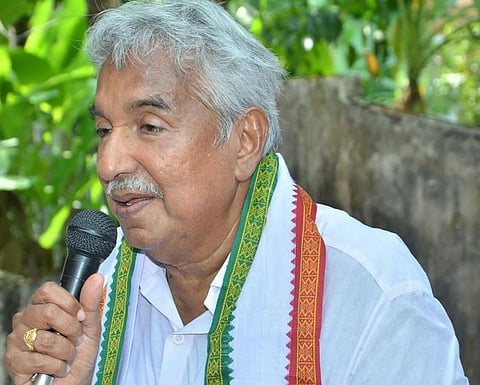 Former Kerala CM Oomen Chandy of the UDF holding a mike